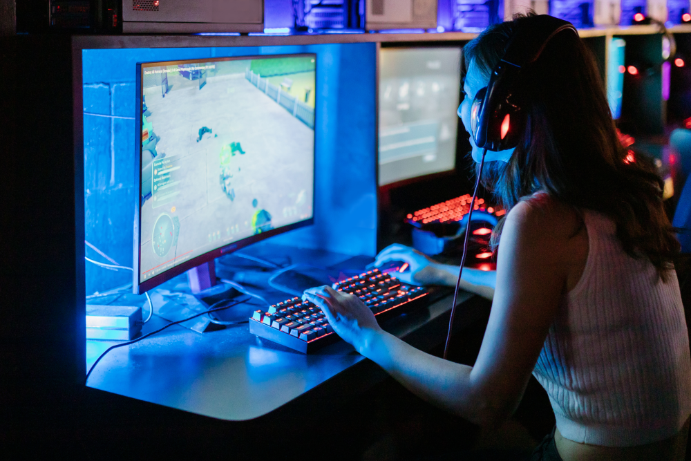 a female gamer playing a video game on a PC