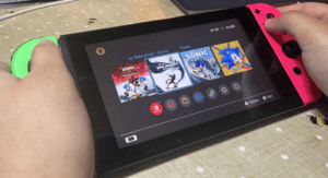 close-up of Nintendo Switch with different games on the home screen