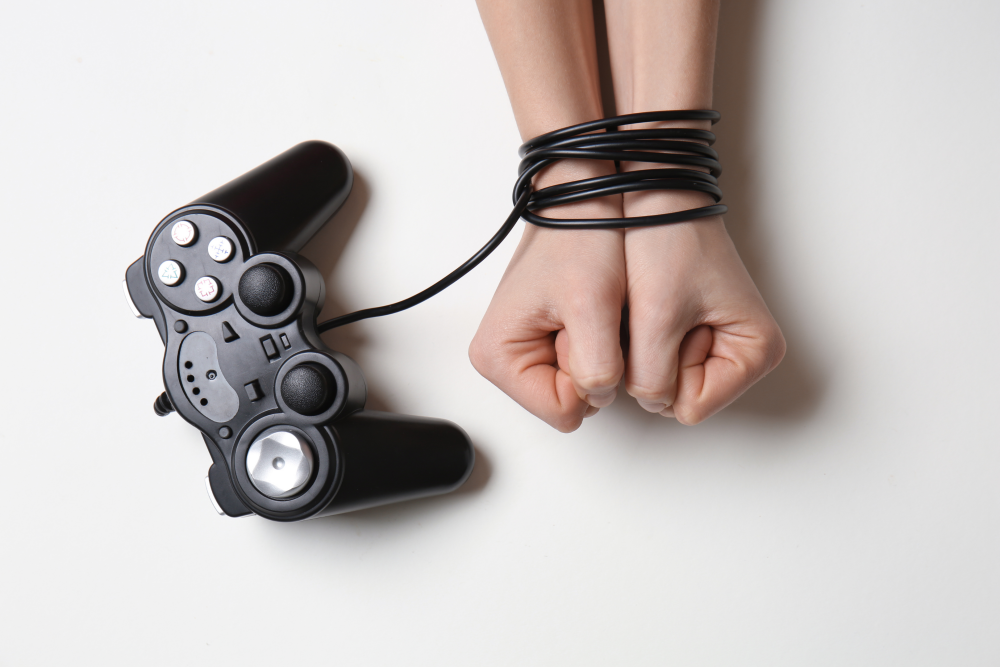 two-wrists tied up by a video game controller cable