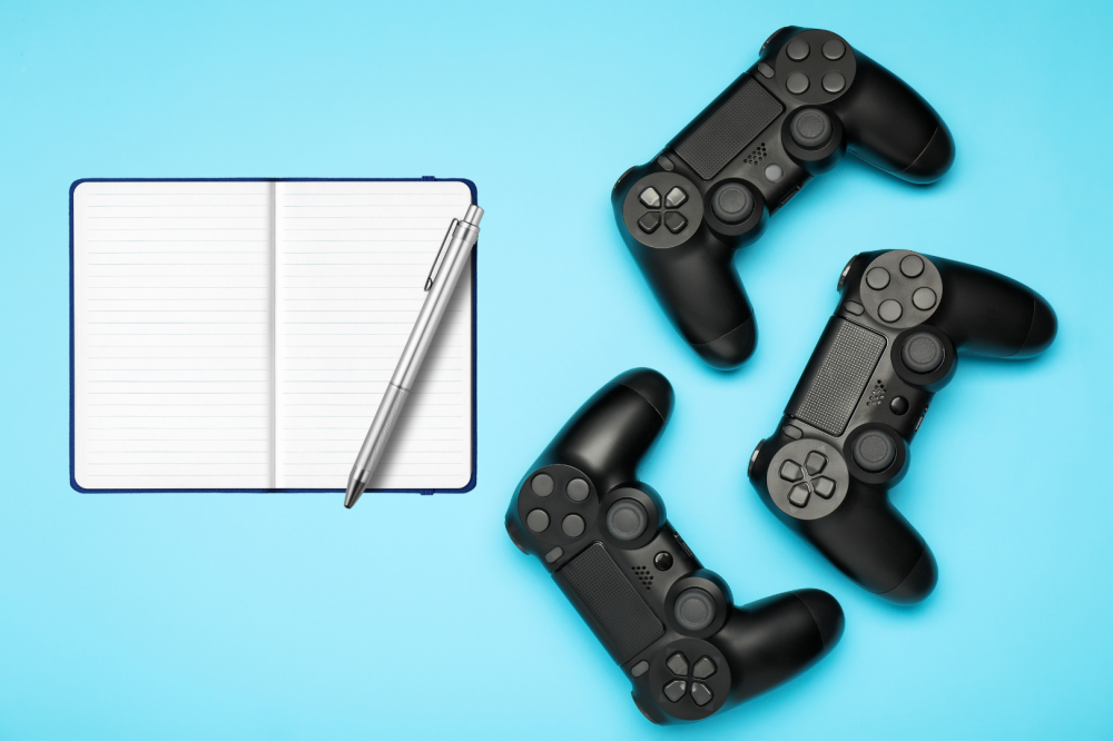 video game controllers and a notebook and pen